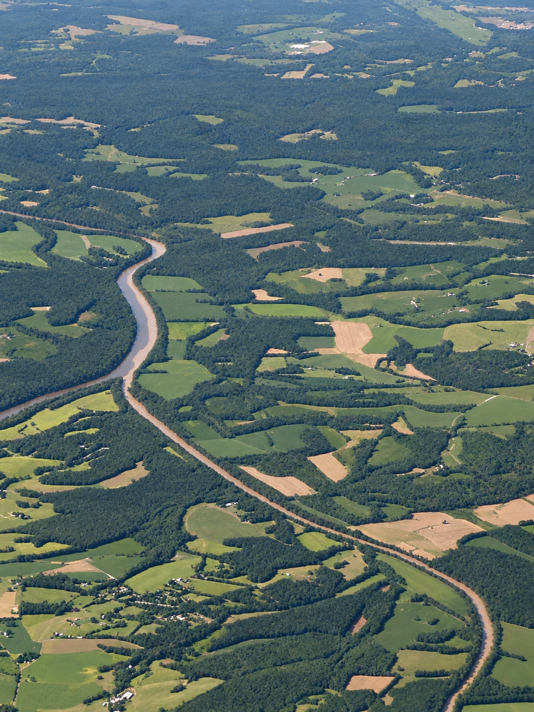 Aerial view showing where the Rocky and Pee Dee Rivers join amid wooded countryside and open farmland